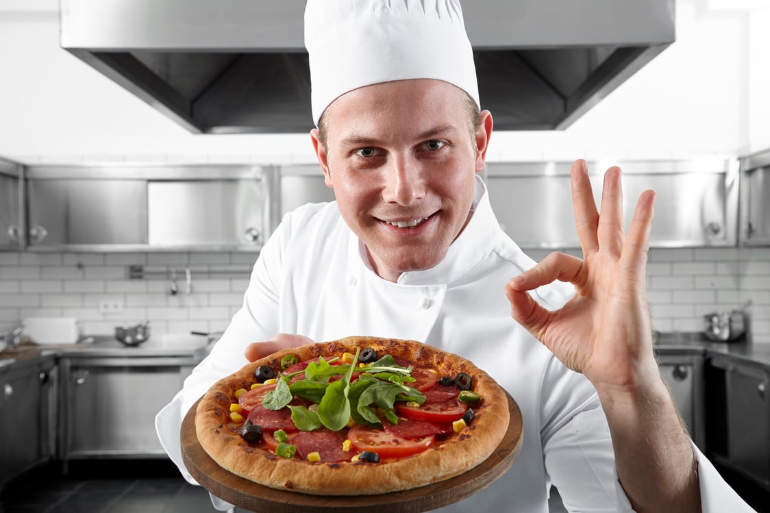 Young pizza chef offers delicious pizza.